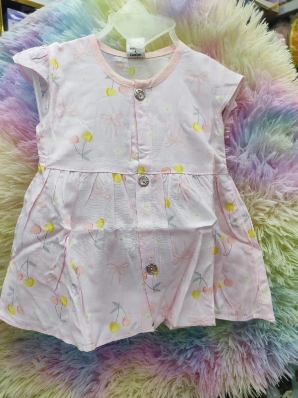 light pink baby girl's sleeveless front-button dress featuring a playful cherry and bow print