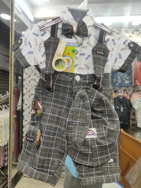 charming baby boy's grey plaid suspender shorts set featuring a matching cap and a playful patterned short-sleeve shirt.